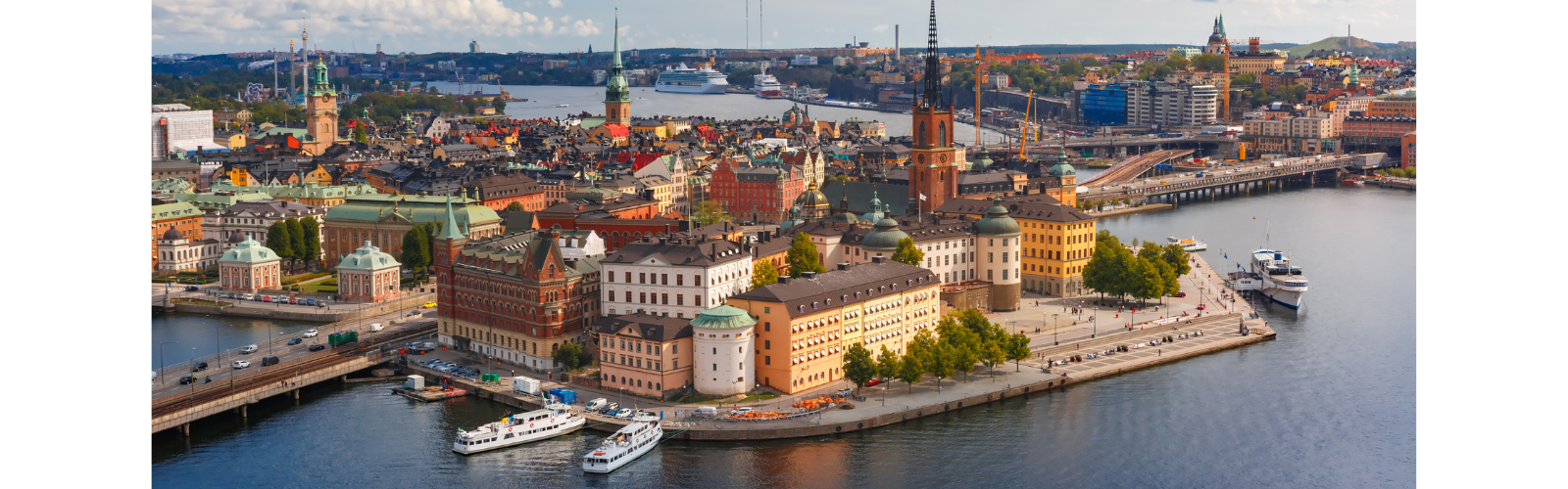 An aerial view of Stockholm. A waterway curves from front to back, while large, varied buildings take up the land.